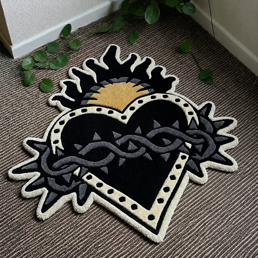 Angle view of the handmade Sacred Heart tufted rug showcasing its unique organic contours and traditional tattoo-inspired artwork on a carpeted floor.