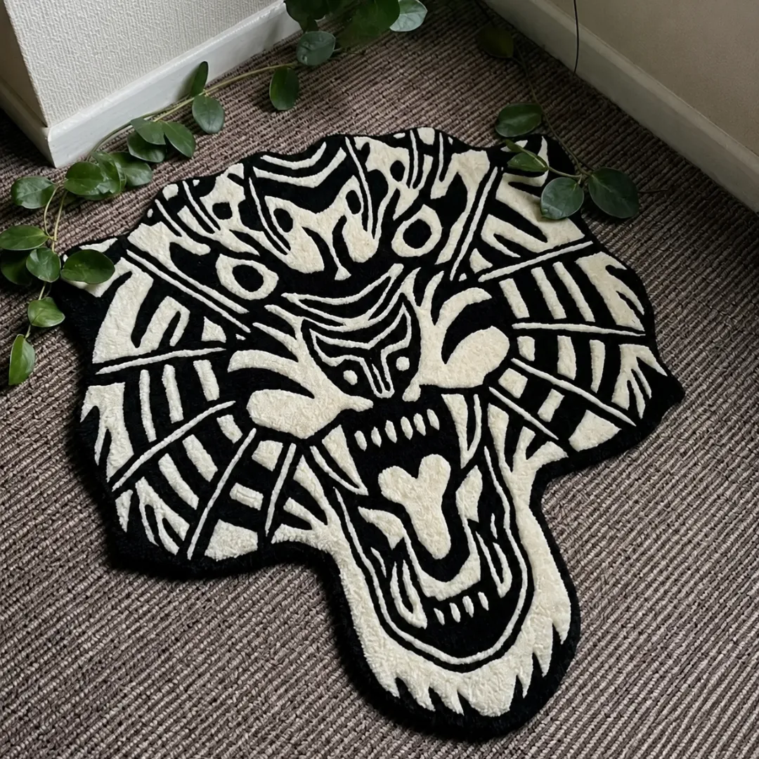 Angle view of the handmade White Tiger Head tufted rug showcasing its unique organic contours and striking black-and-white design on a carpeted floor.