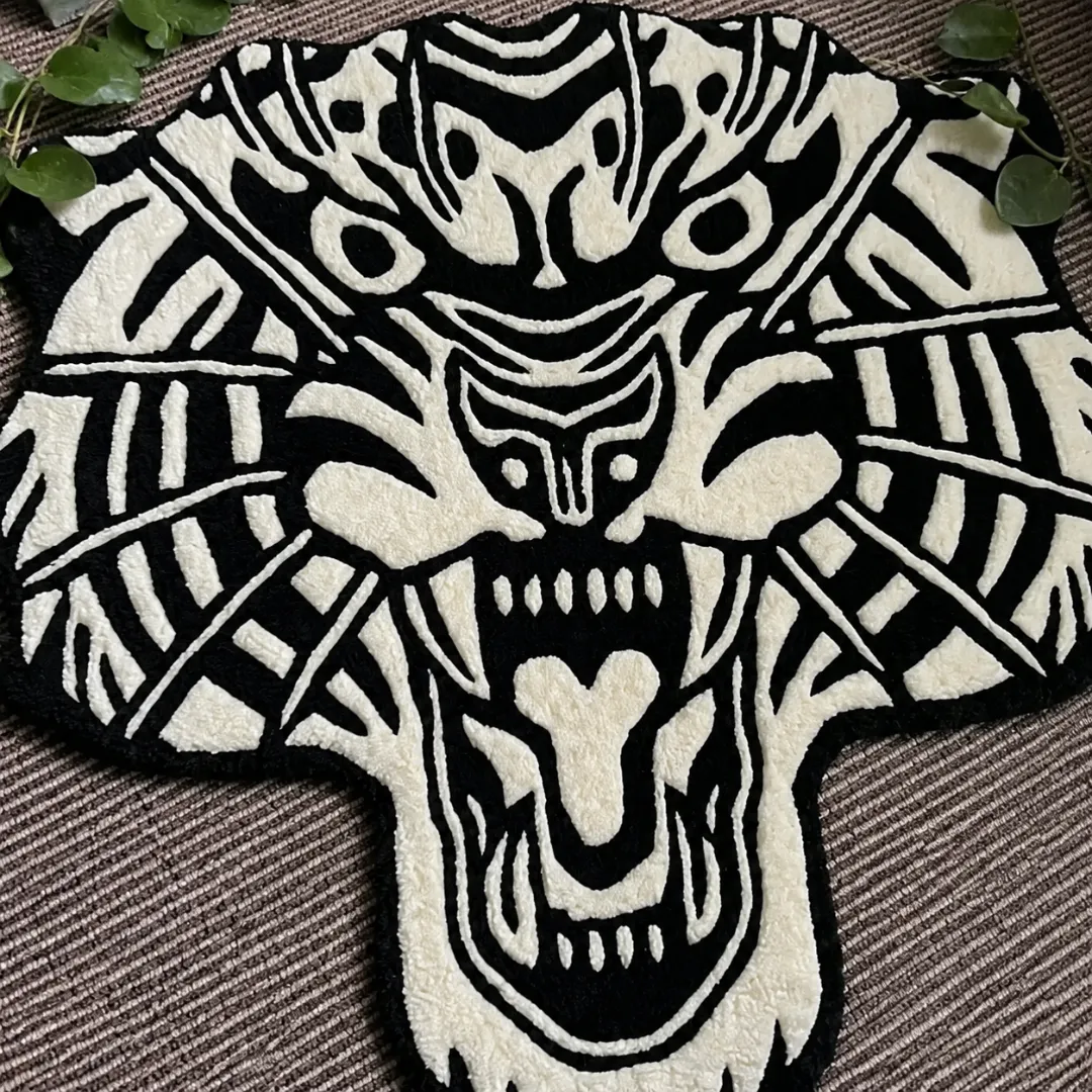 Close-up of the detailed tufted pile texture, fierce snarling expression, sharp fangs, and bold linework on the White Tiger Head rug.