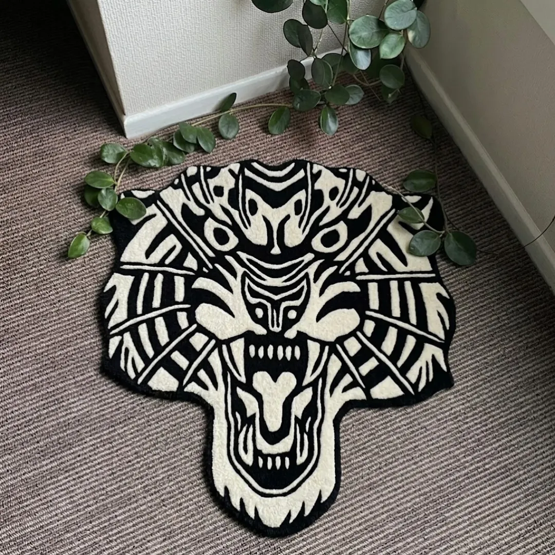 White Tiger Head traditional tattoo style black and white tiger shaped tufted area rug displayed flat on a textured carpeted floor.