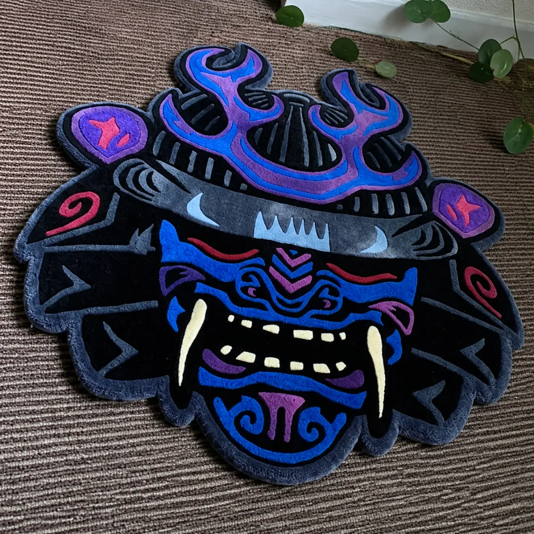 Close-up of the detailed tufted pile texture, fierce demon facial features, and sharp fangs on the Samurai Oni Mask rug.