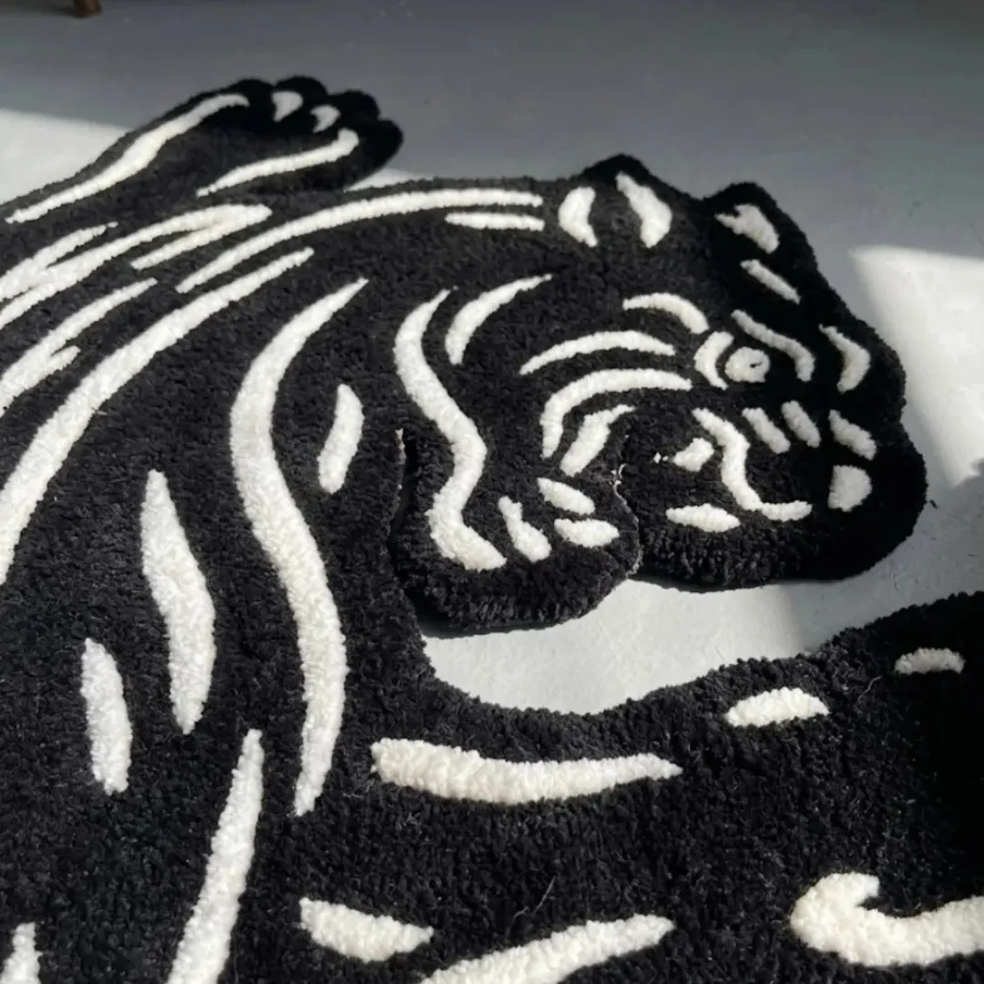 Close-up of the detailed tufted pile texture, striking white cutout lines, and fierce facial features on the Claw Strike Panther rug.