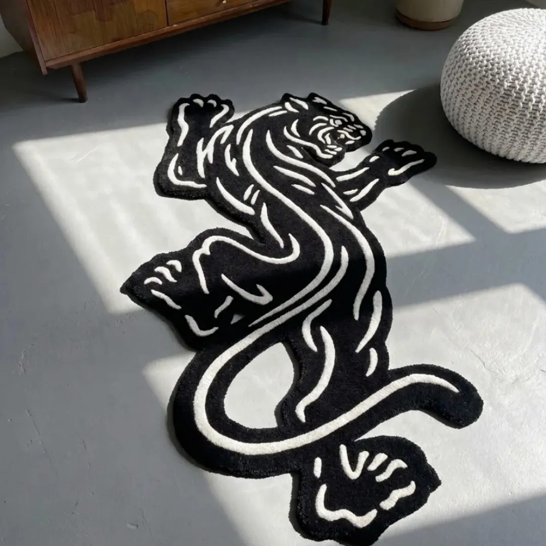 Claw Strike Panther traditional tattoo style black and white shaped tufted area rug displayed flat on a light grey floor.