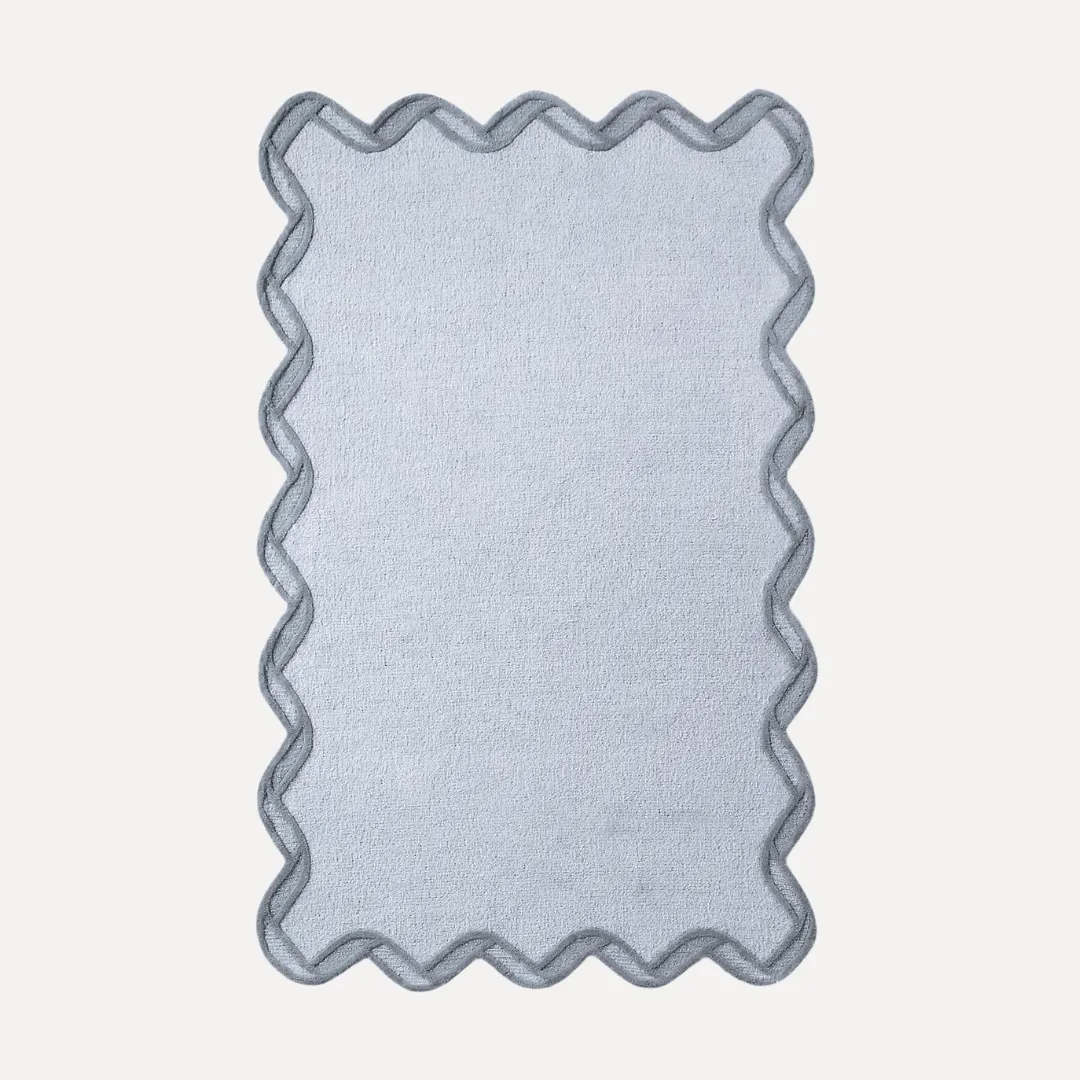 Gray scallop rug with black border and soft curved edge design