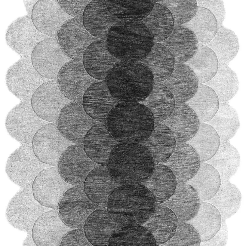 Close-up of scallop edge and gradient texture in monochrome rug