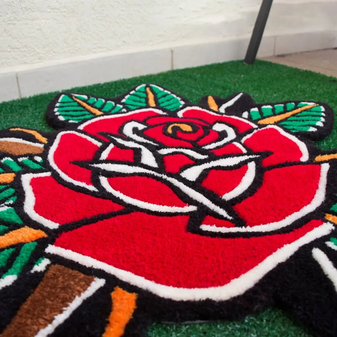 Traditional tattoo-style floral rug with detailed red rose and green leaf patterns.