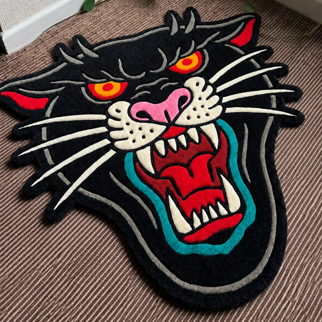 Close-up of the detailed tufted pile texture, snarling open mouth, and sharp fangs on the Roar Panther Head rug.