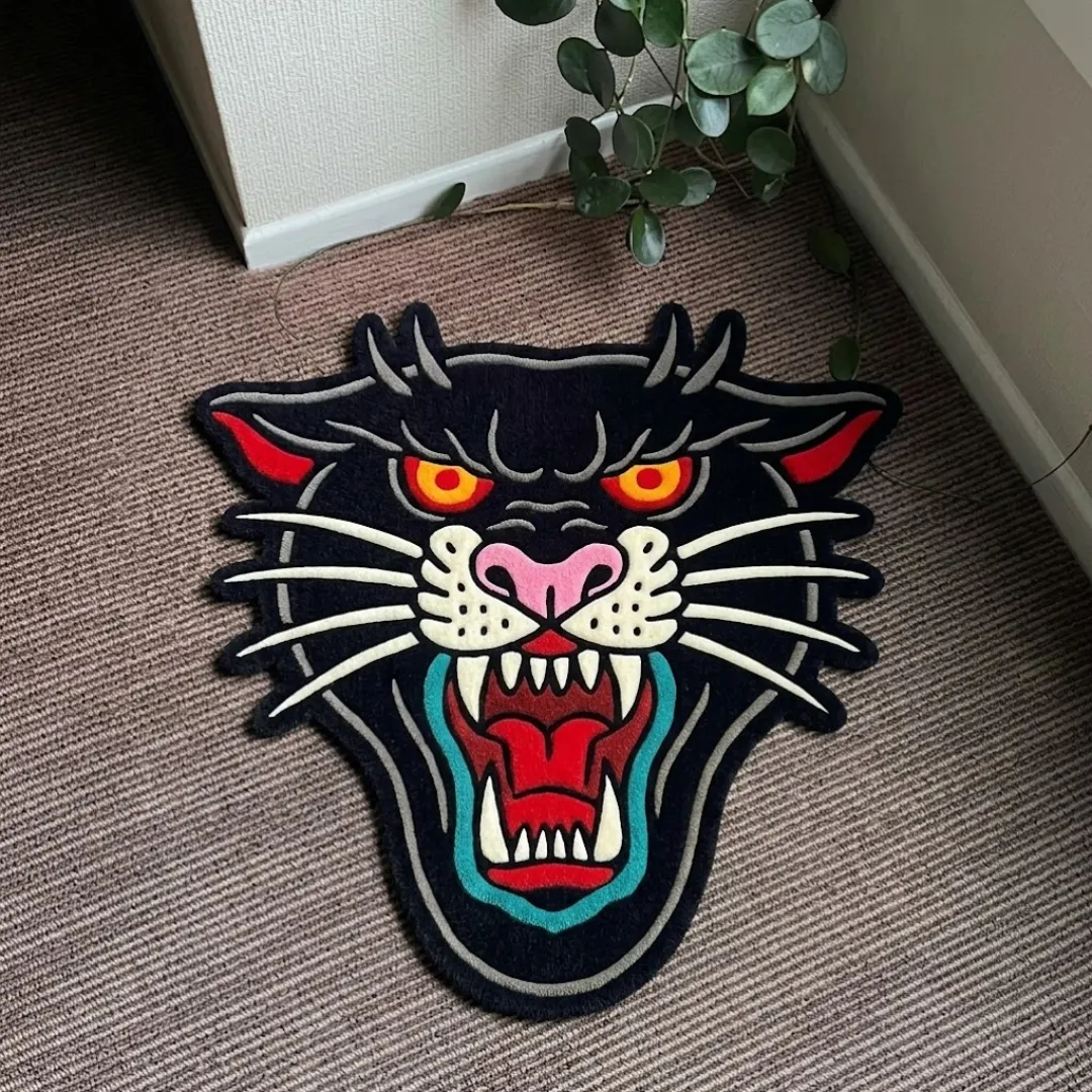 Roar Panther Head traditional tattoo style shaped tufted area rug displayed flat on a carpeted floor.