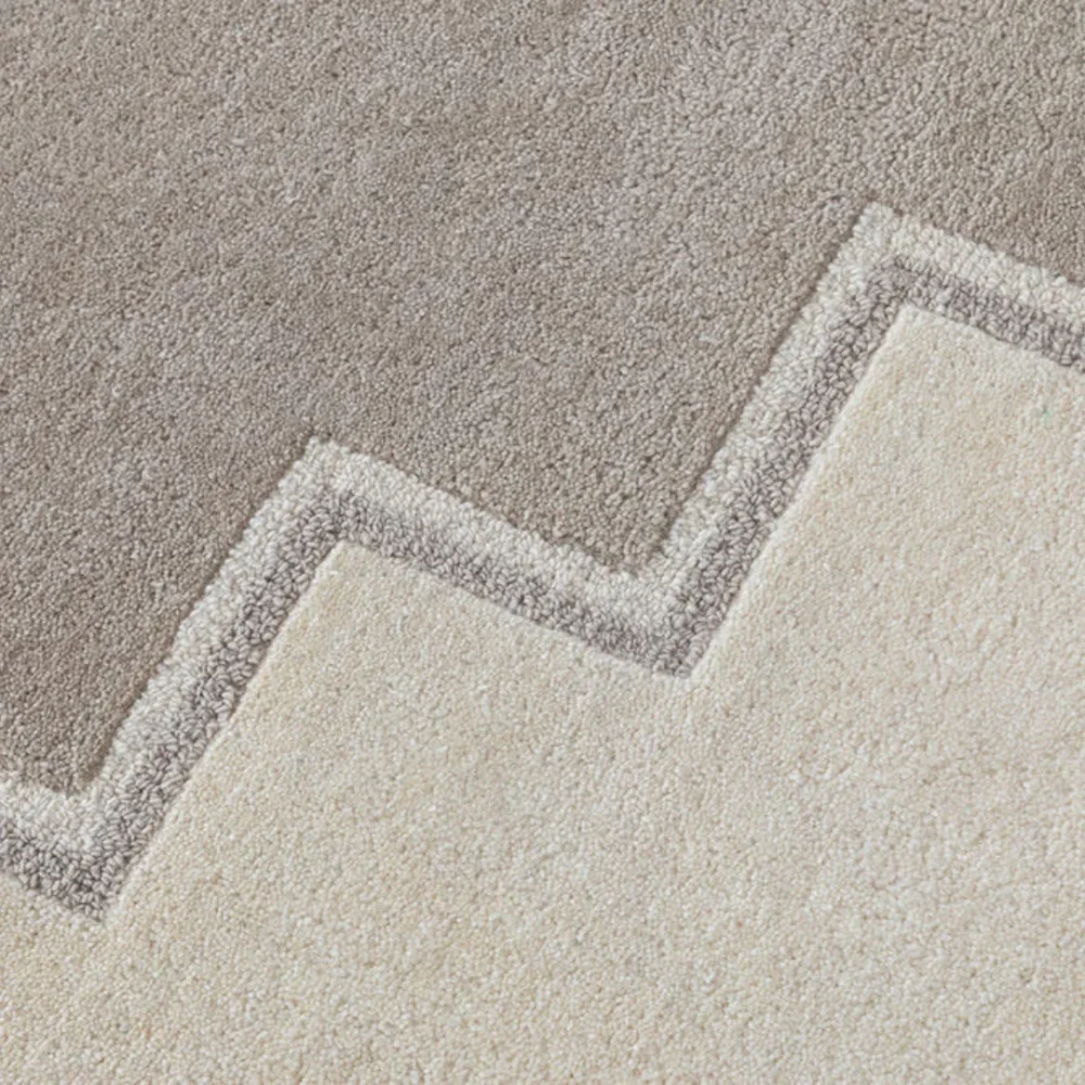Stepped border rug placed in a balanced, modern interior