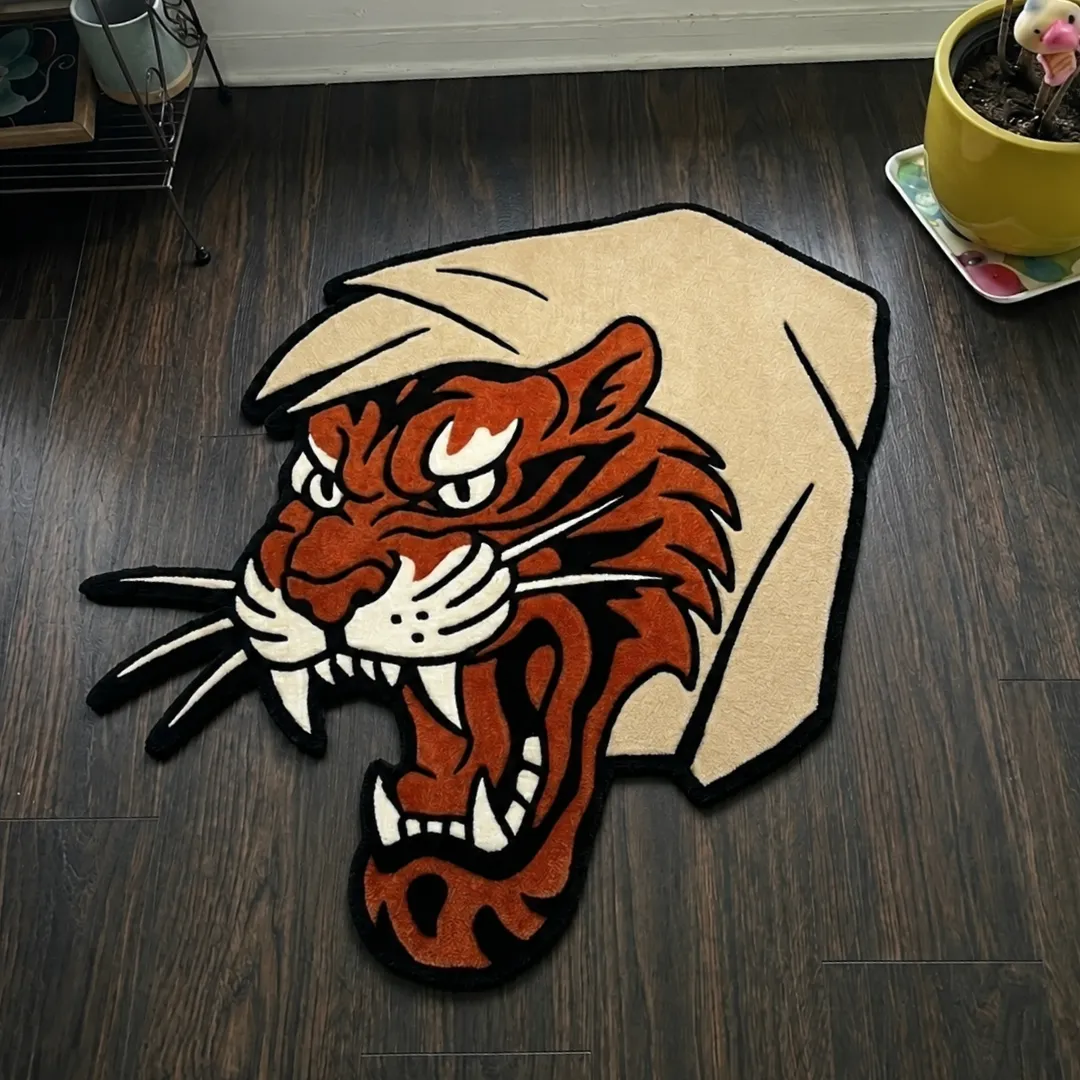 Angle view of the handmade Tiger Bite tufted rug showcasing its unique organic contours and bold color blocking on a wooden floor.
