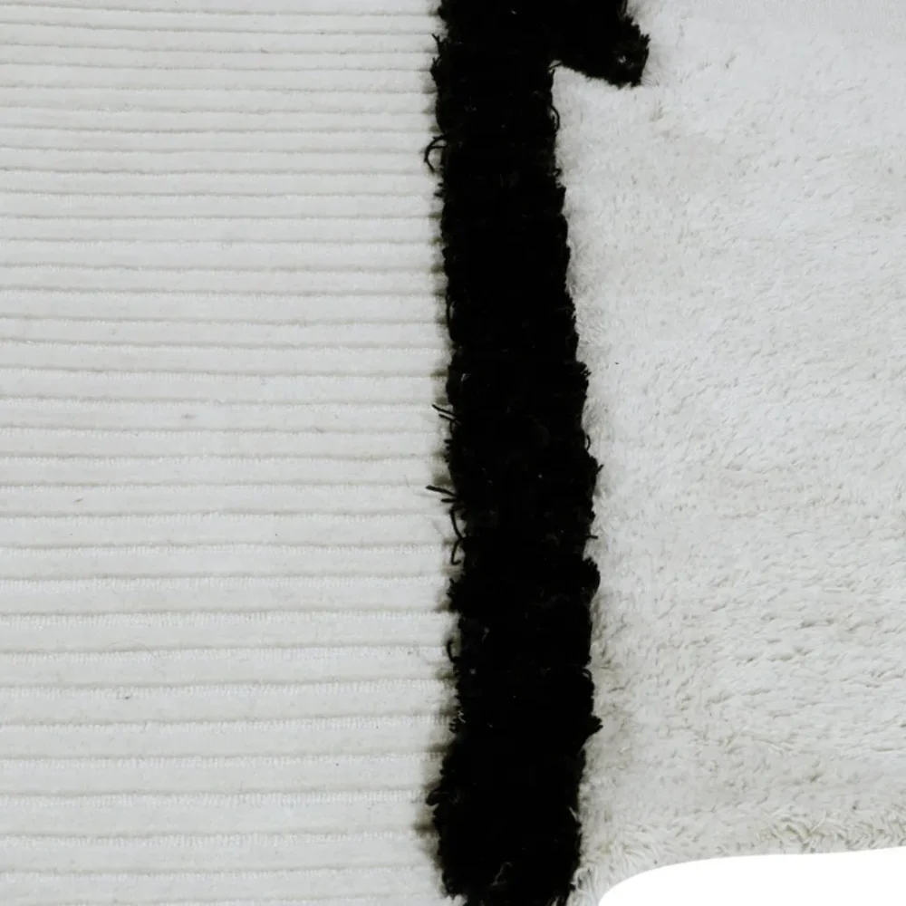Zen-inspired black and ivory rug with ribbed and shag textures