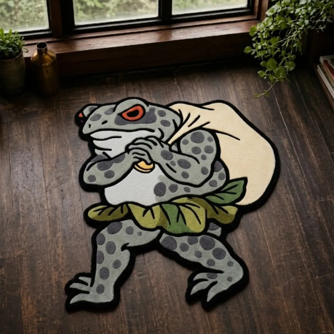 A top-down studio product photograph of a unique, frog-shaped area rug featuring a character carrying a backpack, rendered in detailed shades of grey and green on a dark wood floor.