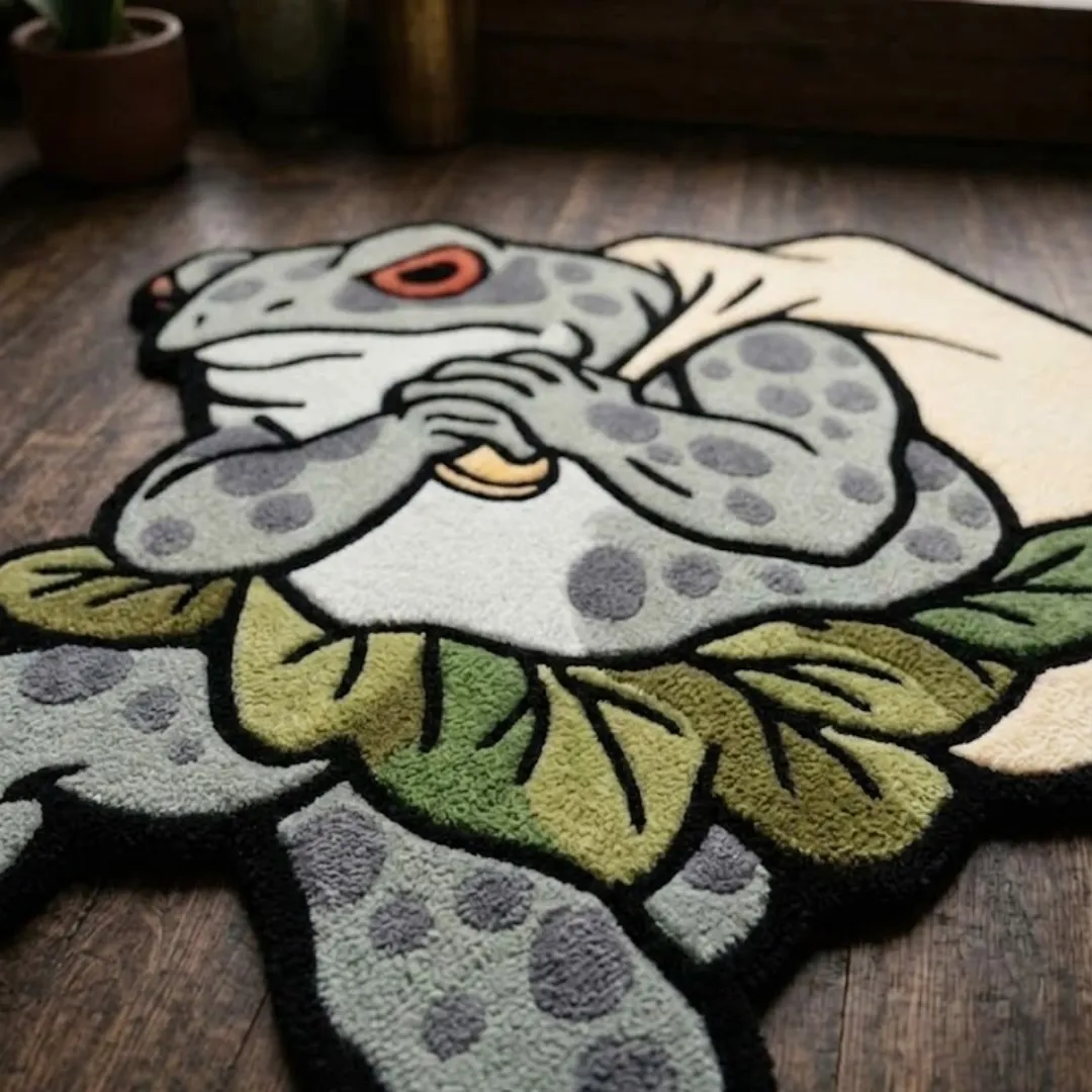 A macro close-up of the backpack frog rug, focusing on the dense, tufted wool pile and the intricate graphic design of the frog character's features.
