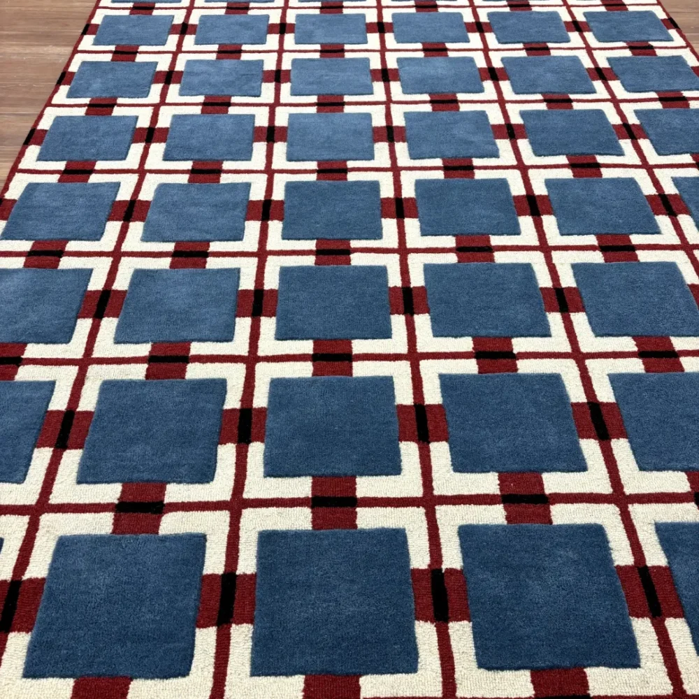 Hand-tufted geometric wool rug with blue squares and red checkered base inspired by Bauhaus style