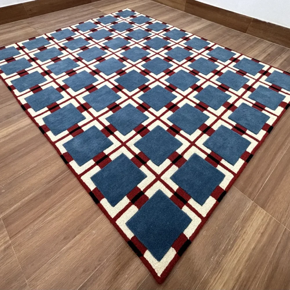 Hand-tufted geometric wool rug with blue squares and red checkered base inspired by German style