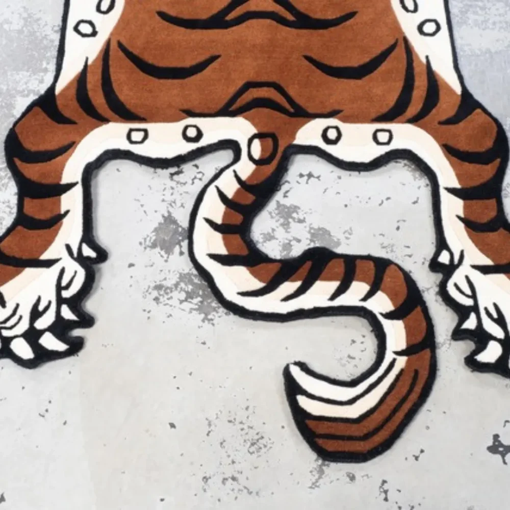 Tiger rug with orange and black stripes, hand-tufted in a flat-lay style inspired by traditional animal motif designs
