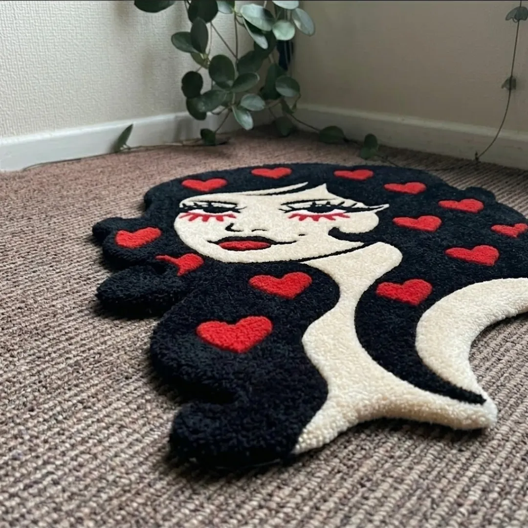 An angled perspective shot of a hand-tufted love lady rug, highlighting its expressive portrait silhouette and high-quality tufted wool texture on a carpeted floor.