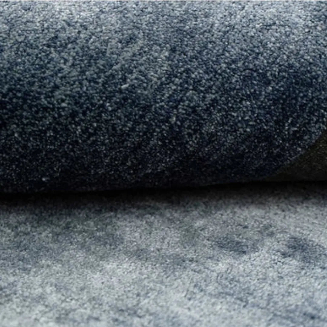 Geometric design blue rug with neutral tones, ideal for modern or minimalist interiors.