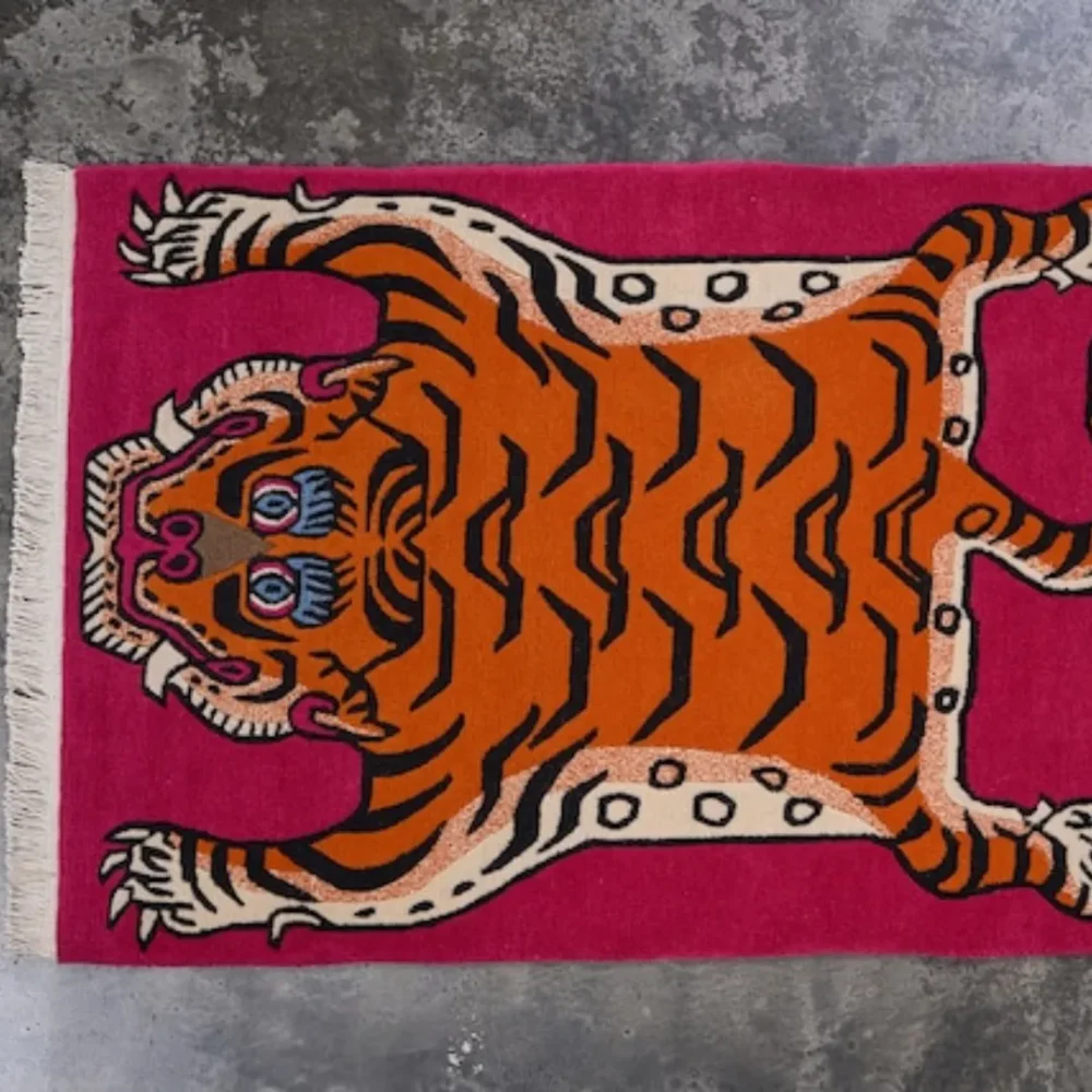 Orange tiger design rug with pink background