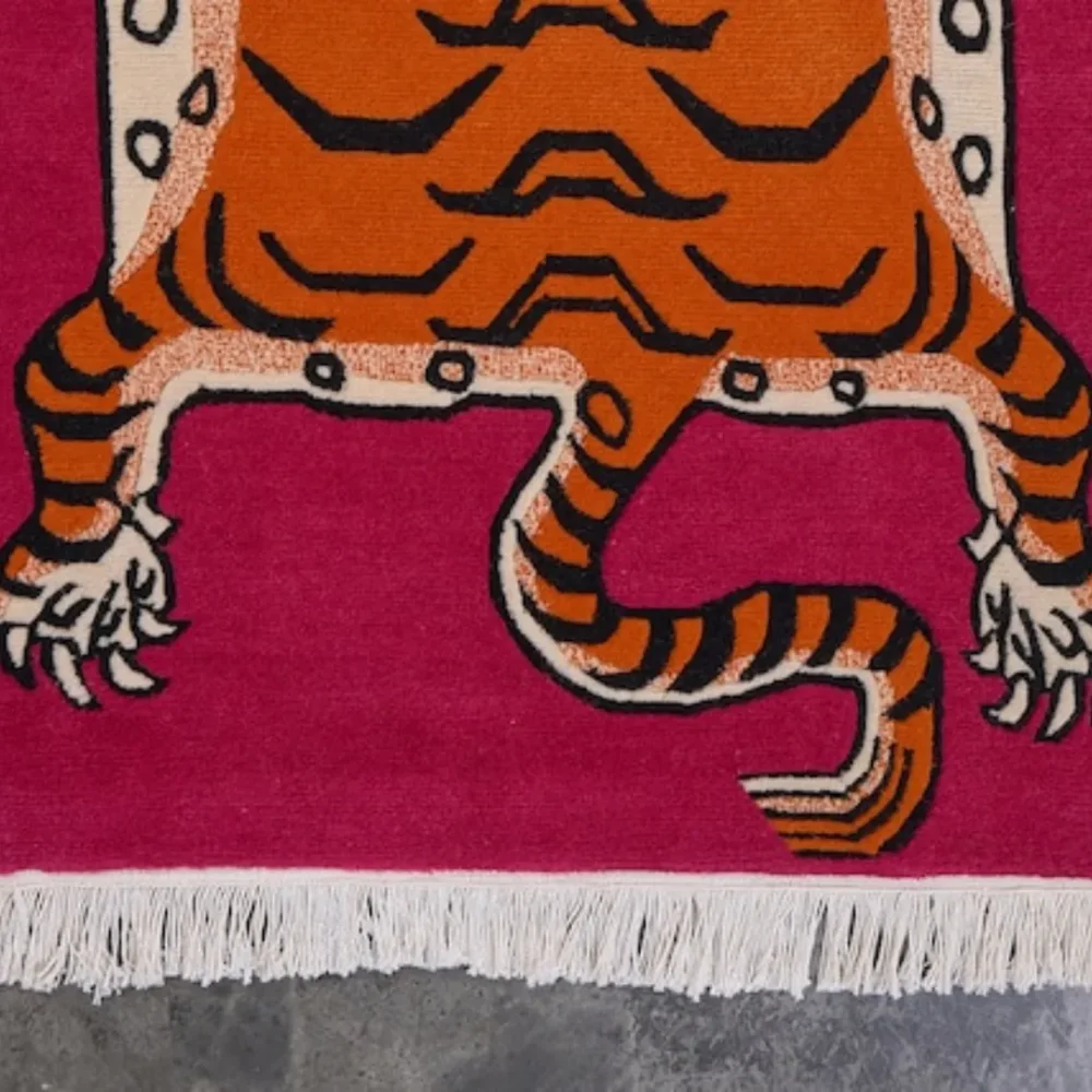 Traditional Tibetan tiger wool rug with white fringe