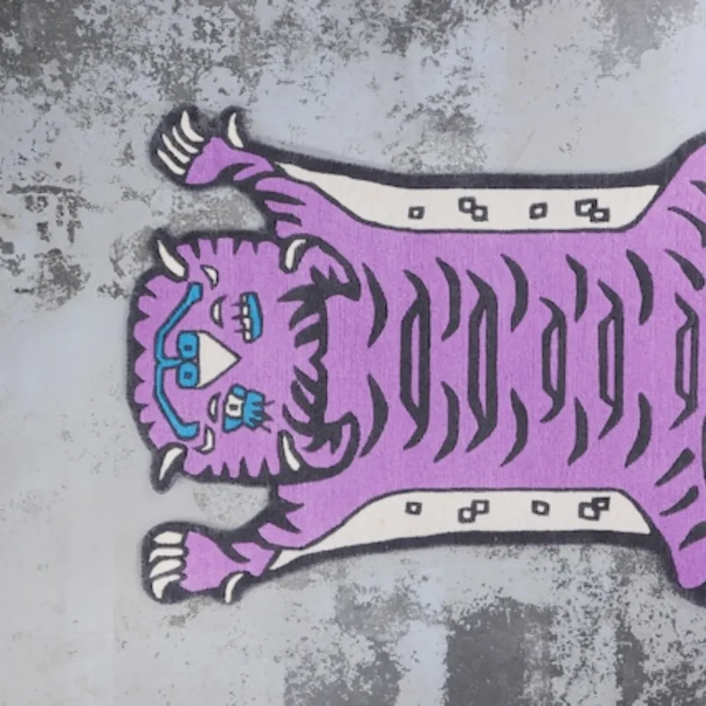 Purple tiger-shaped rug styled in creative modern space