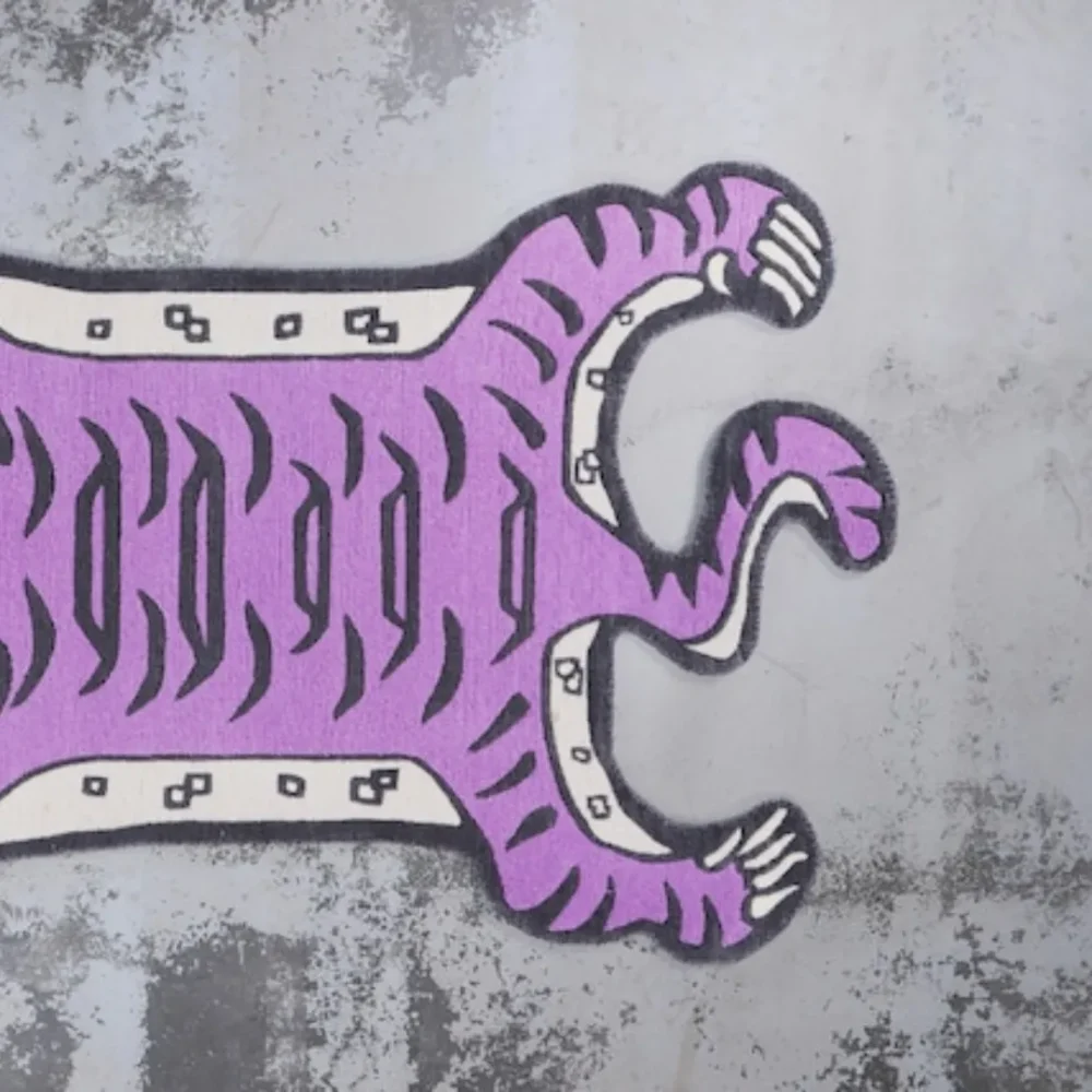 Purple tiger-shaped rug styled in creative space