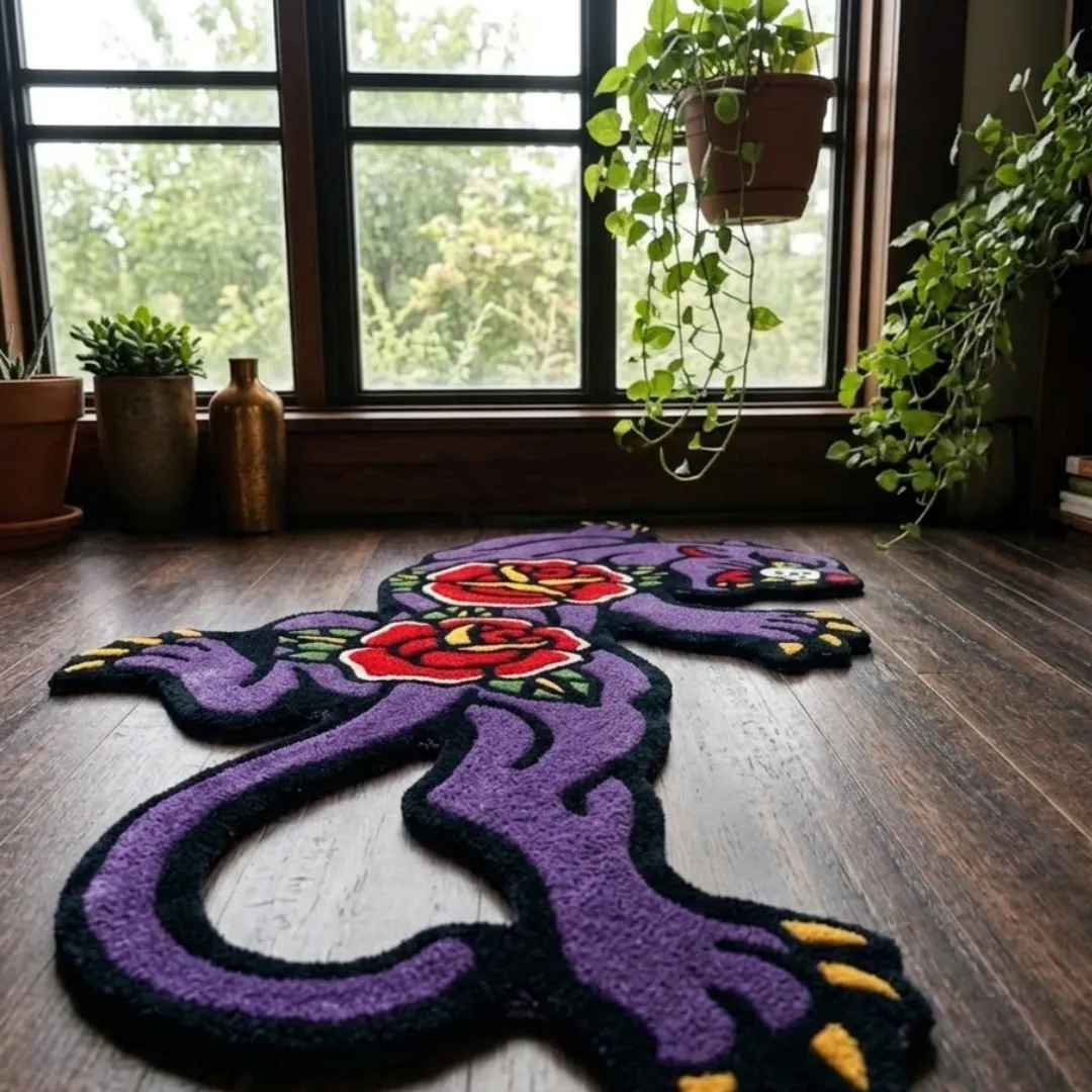 An angled perspective shot of a hand-tufted rose panther rug, highlighting its expressive feline silhouette and high-quality wool texture on a wooden floor.