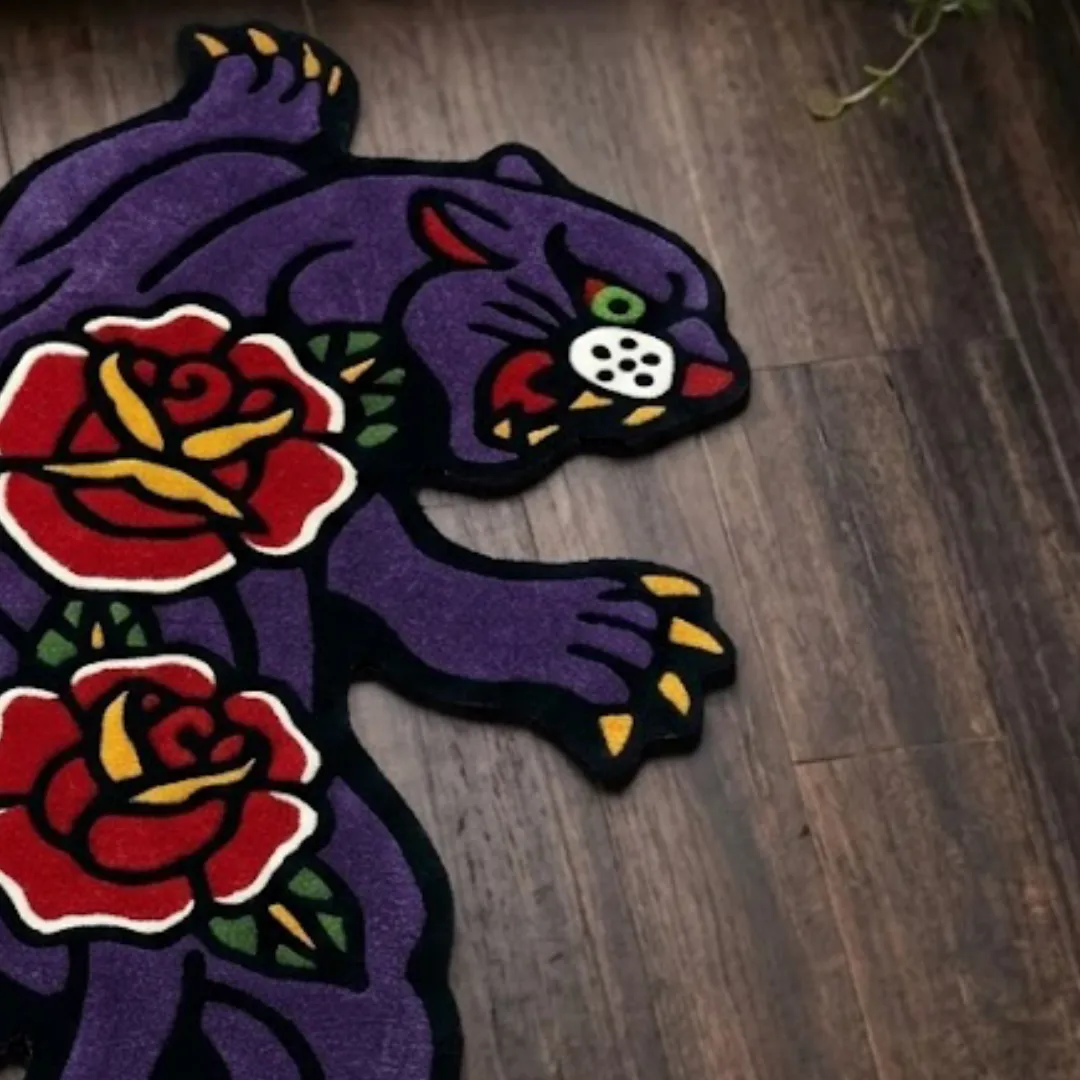 A macro close-up of the rose panther rug, focusing on the dense, tufted wool pile and the intricate graphic design of the panther and rose floral details.