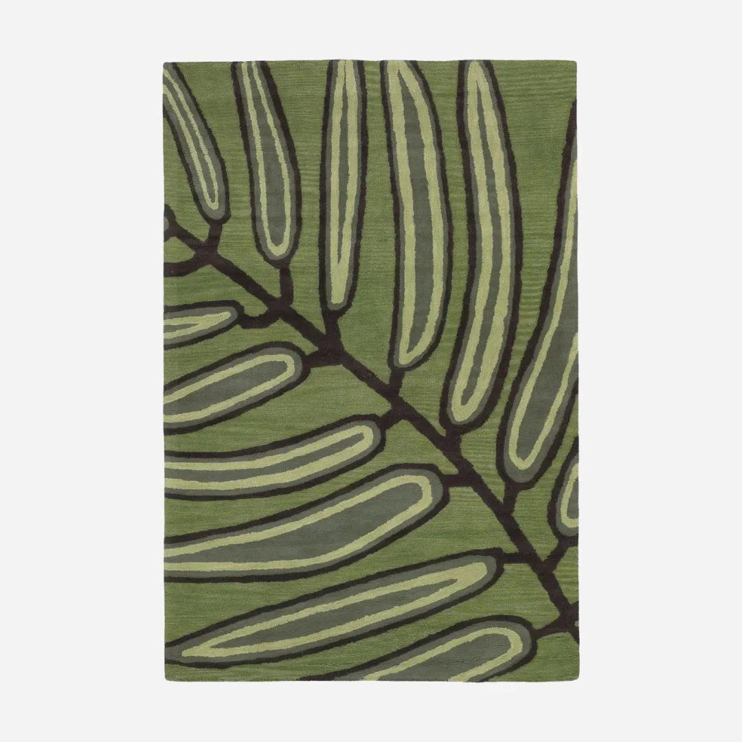 Green wool rug with tropical leaf pattern