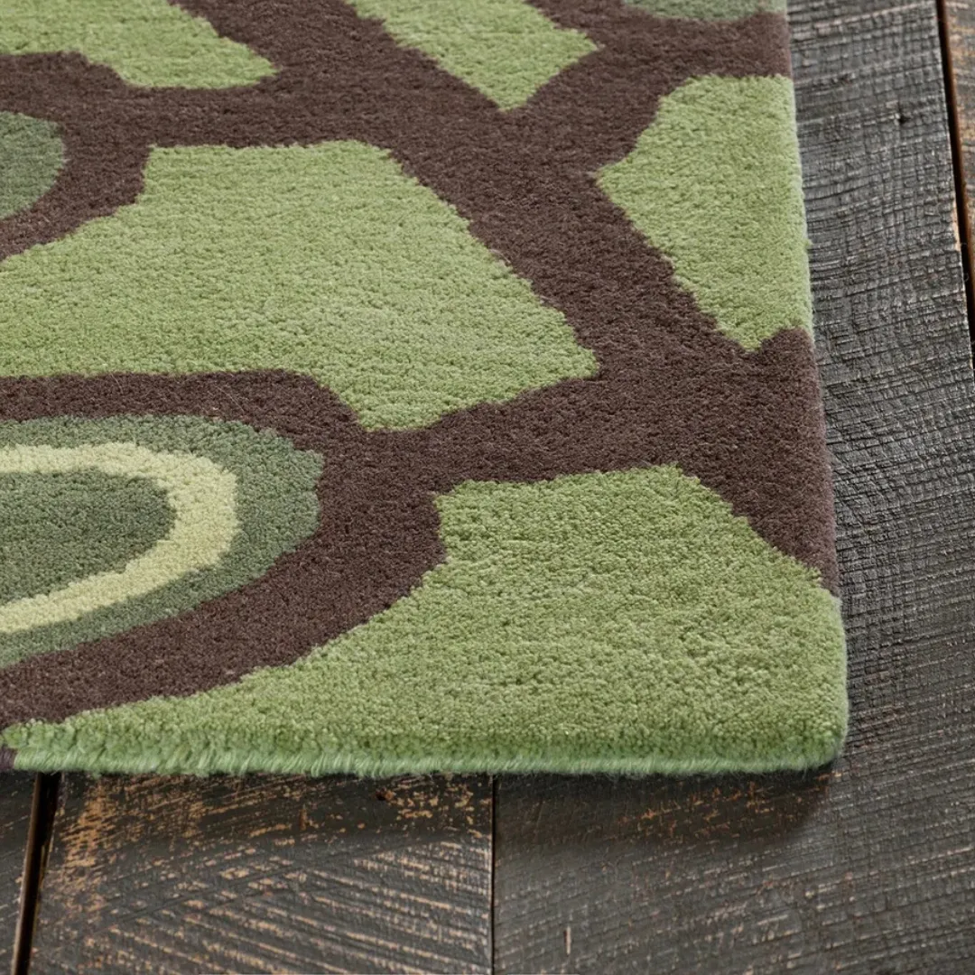 Bold tropical leaf design rug in various shades of green
