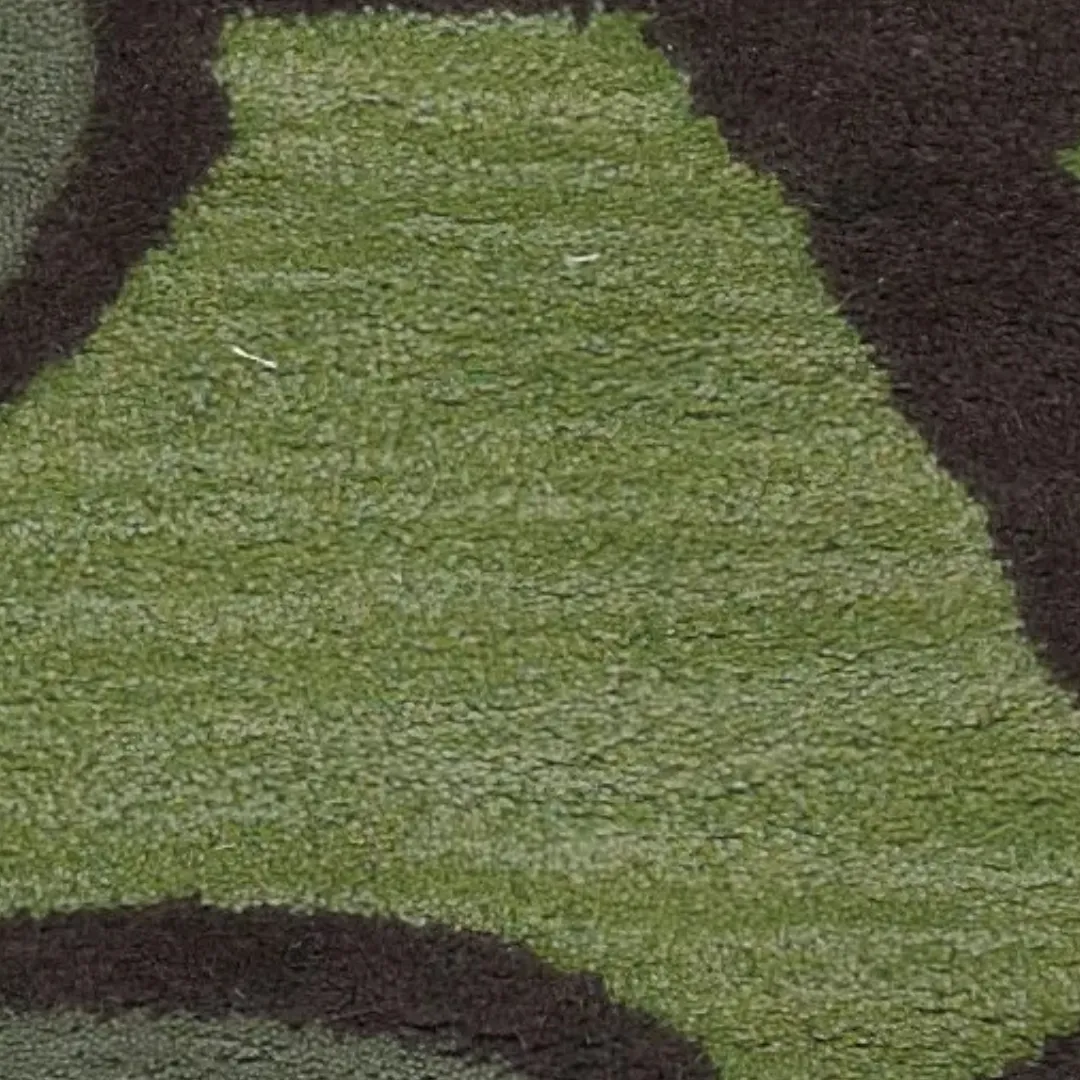 Handmade wool rug with earthy green tropical leaf design