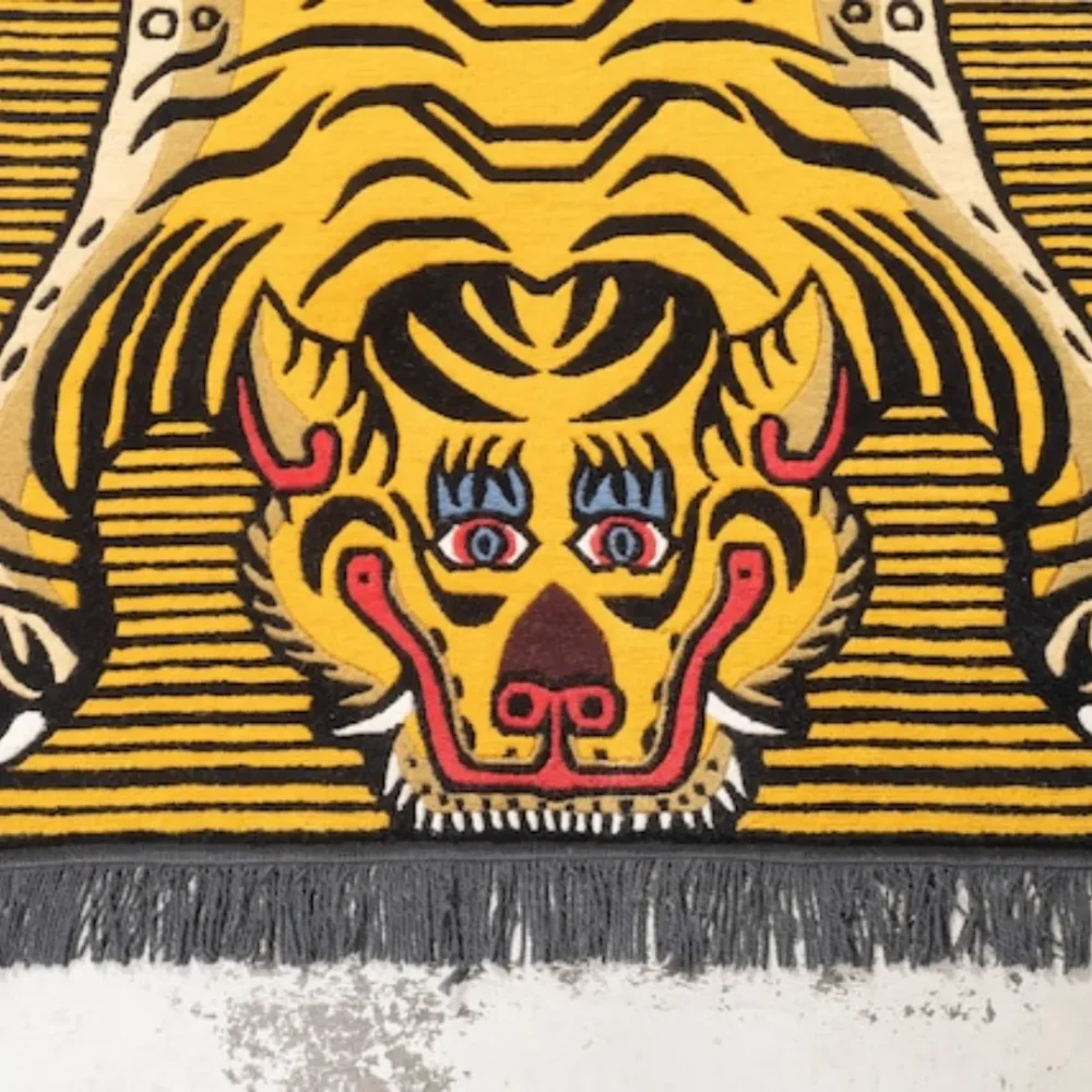 YellowTibetan tiger rug with black stripes and red eyes