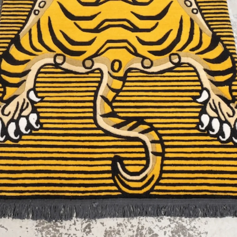 Yellow striped Tibetan tiger area rug with animal print design, perfect for bold interiors