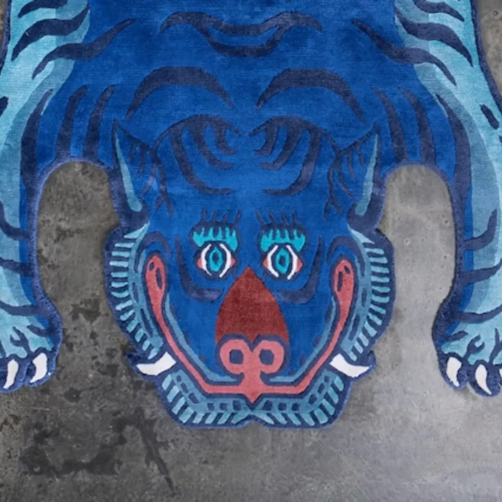 Close-up of the playful and fierce blue tiger face design on the Blue Mirage rug