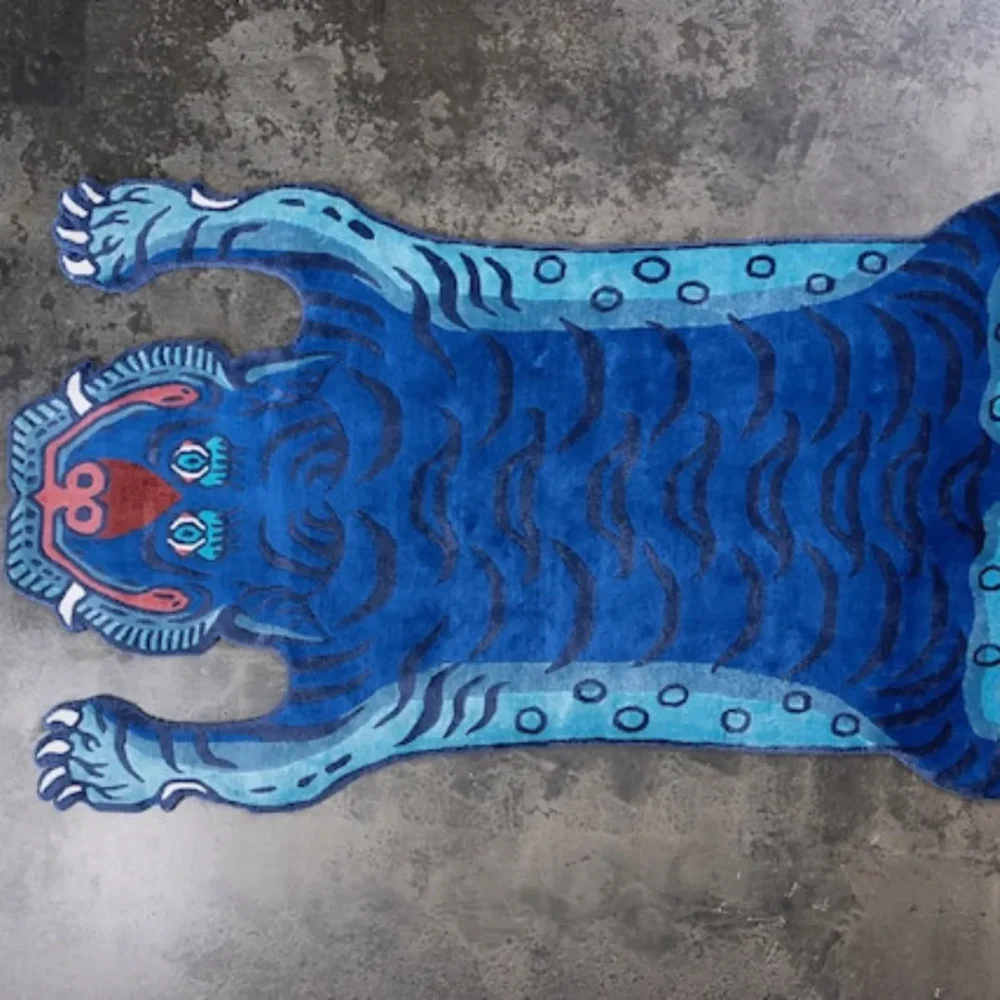 Fierce blue tiger features with red accents on the Blue Mirage Rug