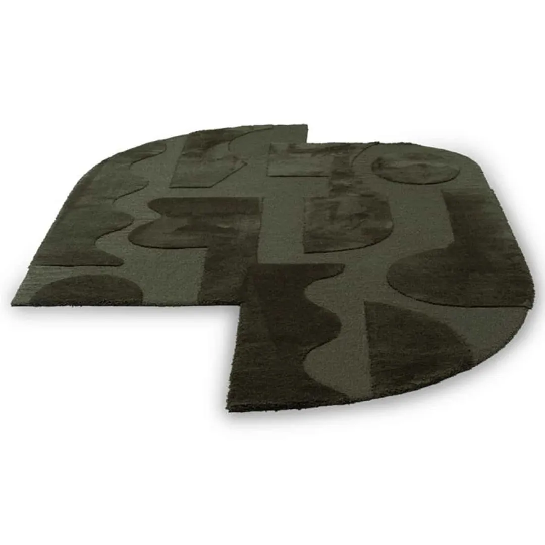 Modern area rug featuring abstract faces and shapes in dark green.
