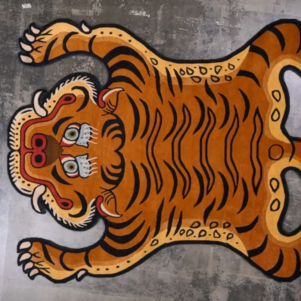 Close-up of the detailed tiger face in earthy tones of gold, black, and brown