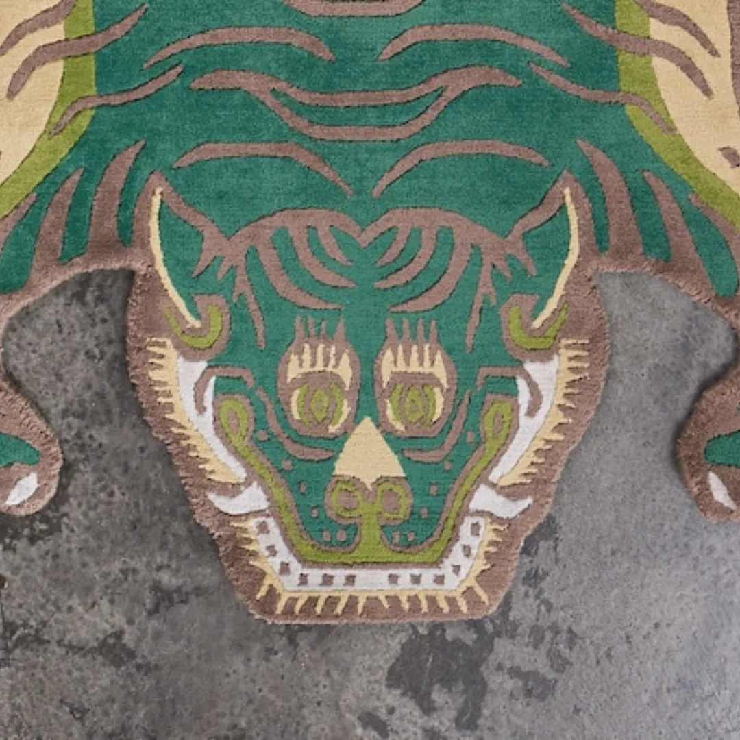 Close-up of the vibrant green tiger face design on the Jungle Guardian Wool Rug