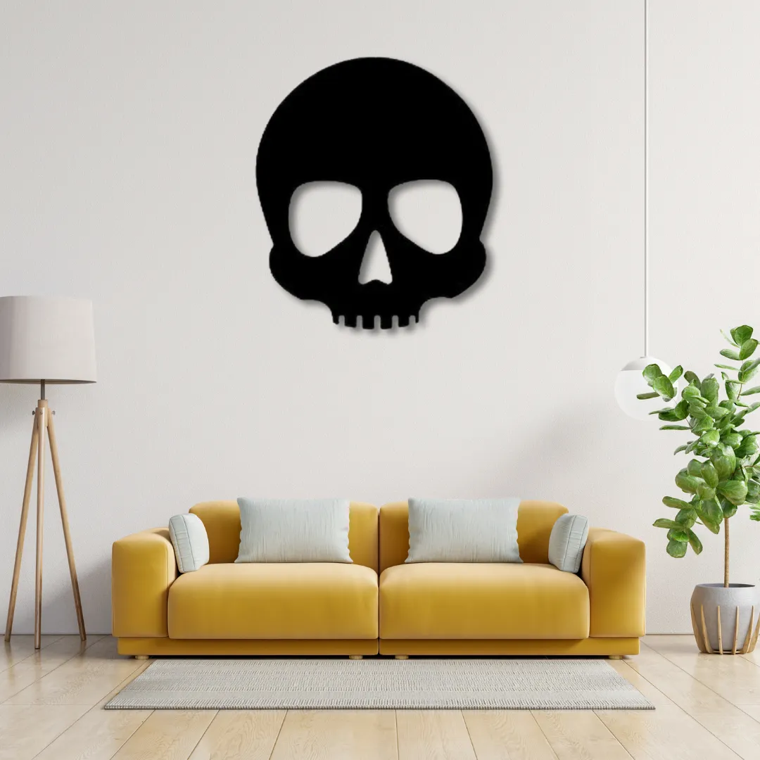 Black skull silhouette metal wall decor above yellow sofa