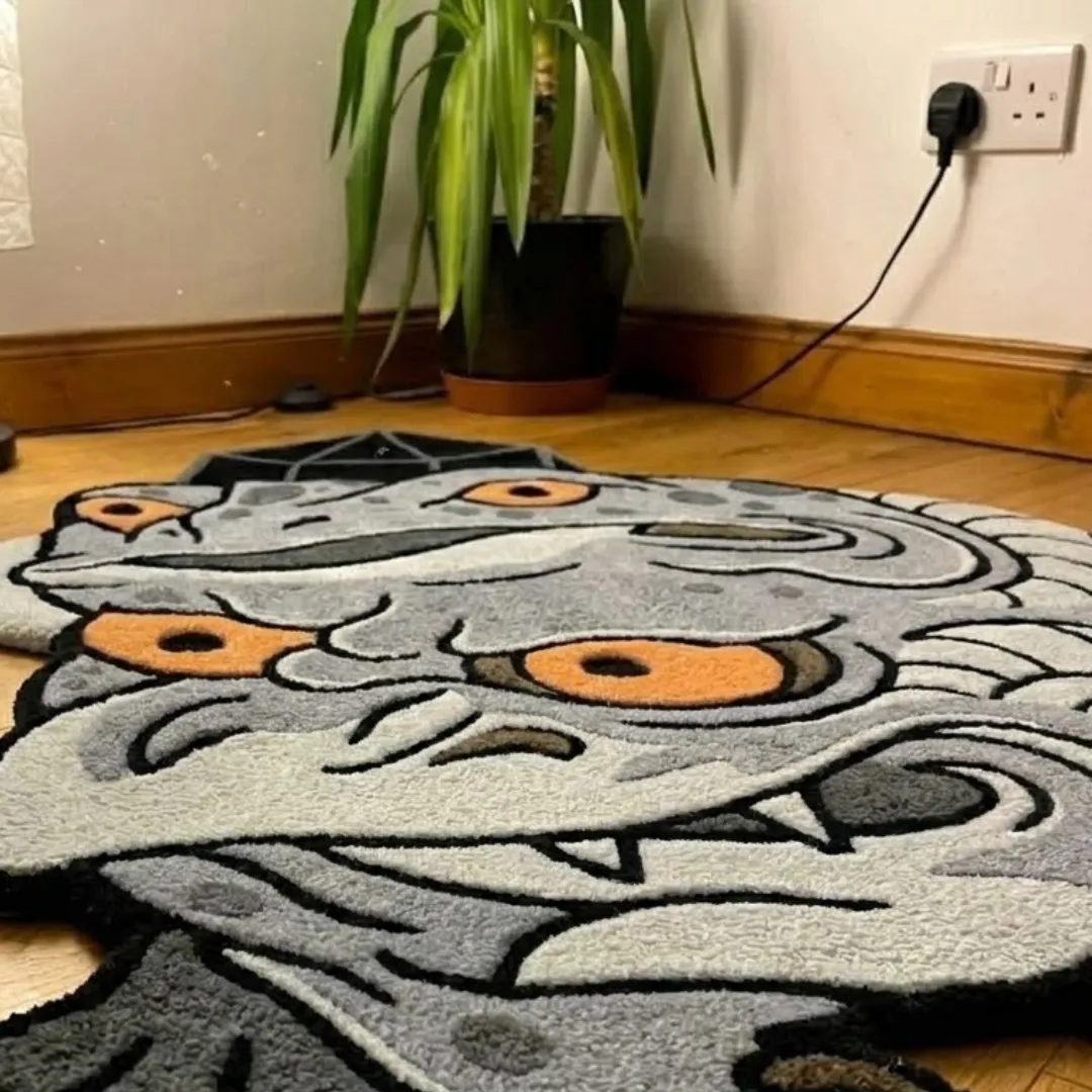 A macro close-up of the quirky frog demon rug, highlighting the dense, high-quality tufted wool texture and the graphic linework of the two-headed creature design.