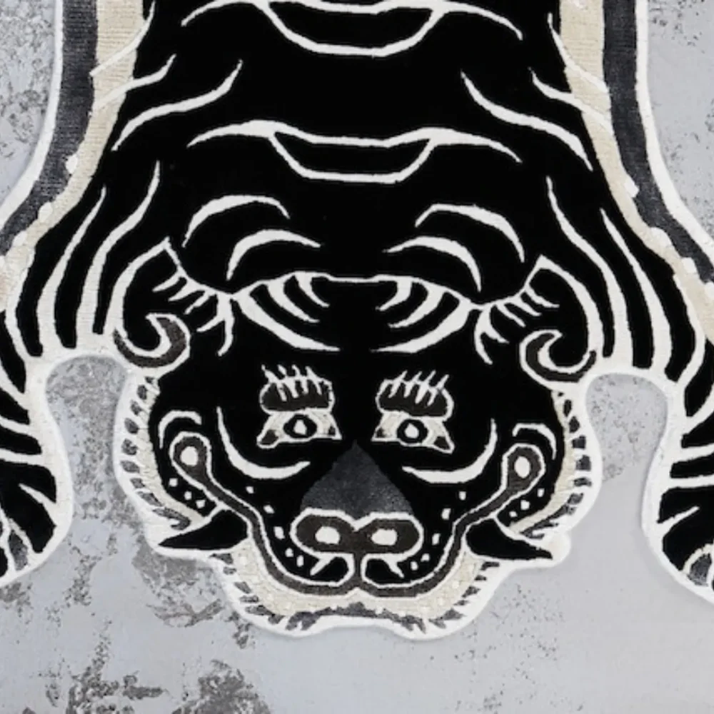 Close-up of the fierce tiger face design in black and white on the Shadow Stripes rug