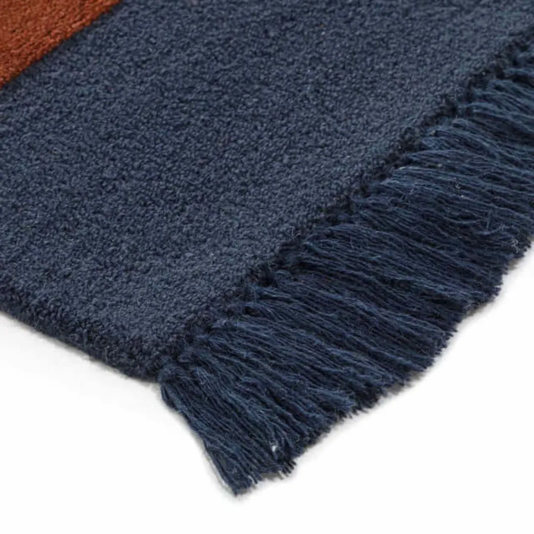 Modern abstract rug with frayed edges and rich color blocking.