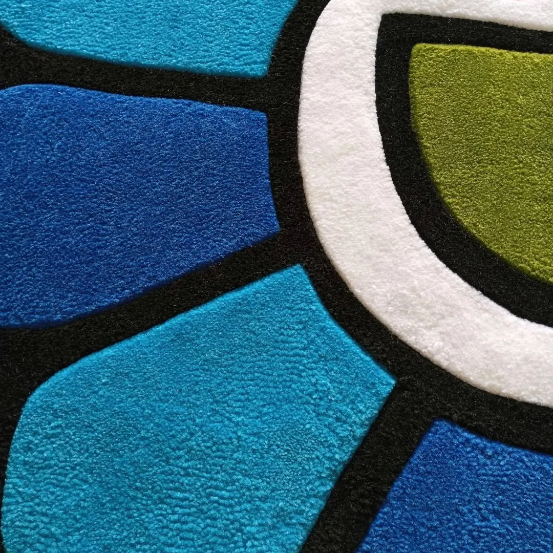 Blueberry Mirage Takashi Rug Vibrant Blueberry Mirage Rug featuring gradient blue petals, a white center, and colorful eyes, made from premium tufted wool.