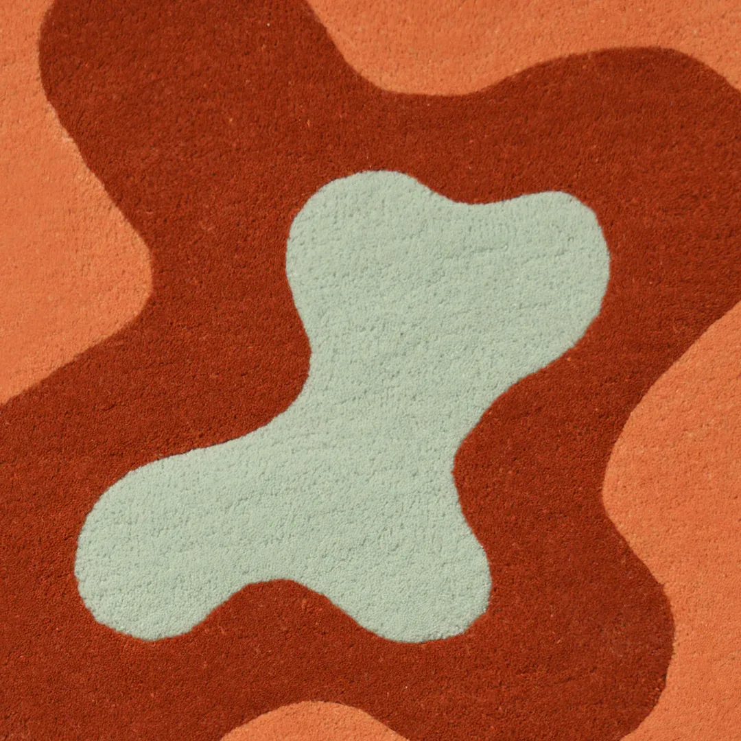 Hand-tufted Ember Flow Rug showcasing abstract layered wave design inspired by molten textures