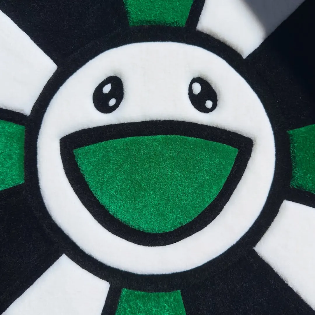 Emerald Takashi Rug Vibrant Emerald Bloom Rug crafted from soft wool, showcasing alternating green and white petals outlined in bold black for visual contrast.