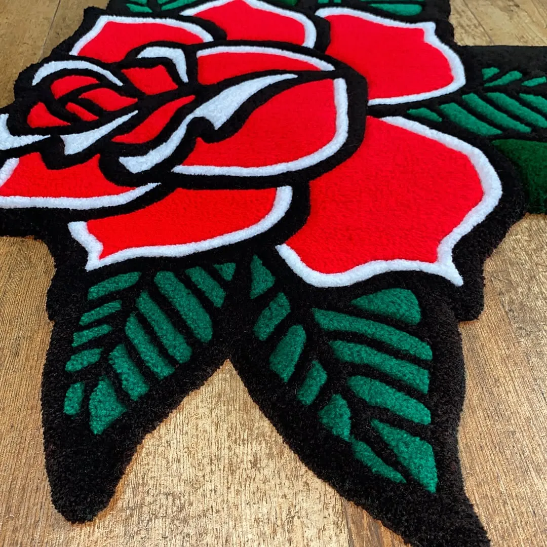 Hand-tufted Nocturne Bloom Tattoo Rug showcasing bright red flower with artistic black outlines