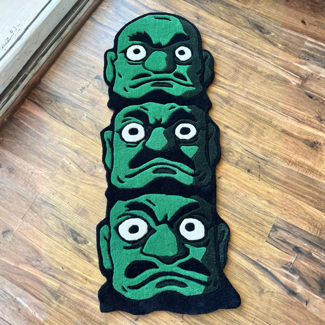 Bold Oni Trinity Rug with triple-face demon design in green and black tones – handmade tufted wool rug