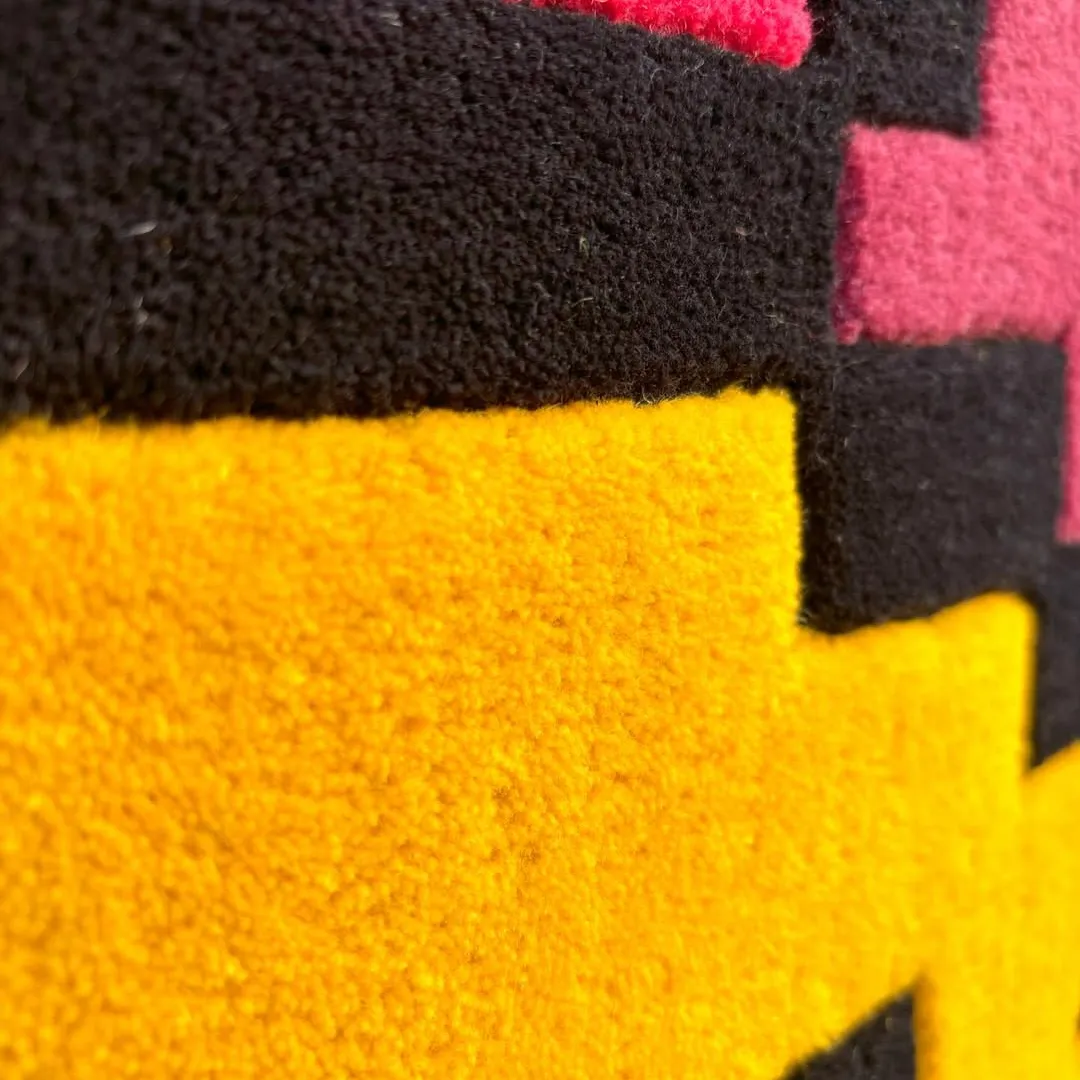 Colorful Smiley Pixels Rug featuring hand-tufted wool craftsmanship, with bright yellow, blue, red, and green pixel blocks.