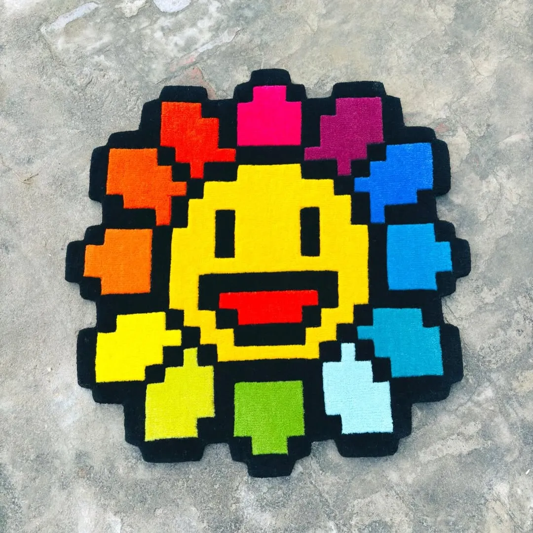 Smiley Pixels Rug – Hand-tufted wool rug with a pixelated smiling face design in vibrant rainbow colors, inspired by digital pop art.