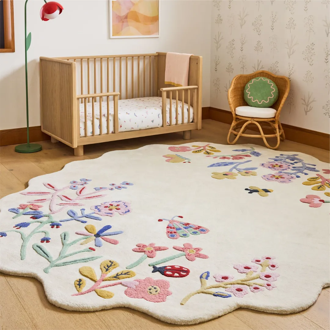 Hand-tufted Honey Lull Meadow Rug with scalloped edges and colorful meadow flowers